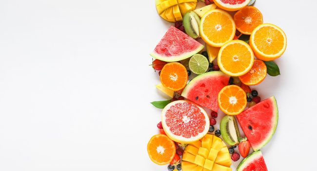 Sweet ripe fruits and berries on white background